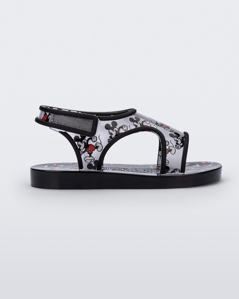 Side view of black Mini Melissa Acqua sandal with Mickey Mouse print.