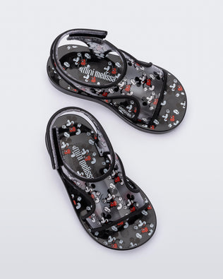 Top view of a pair of black Mini Melissa Acqua sandals with Mickey Mouse print