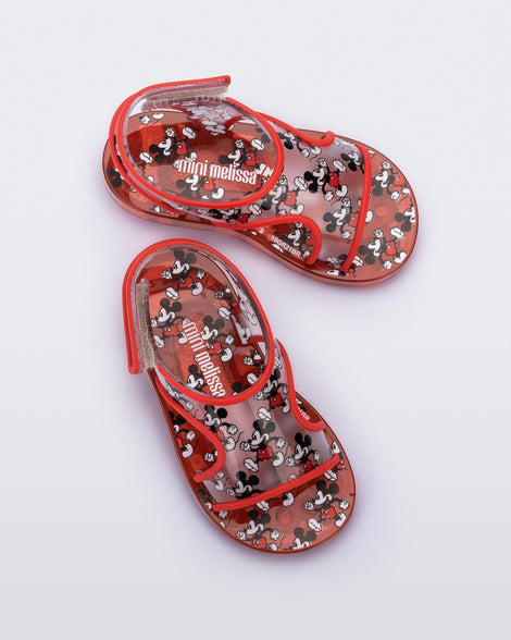 Top view of a pair of red Mini Melissa Acqua sandals with Mickey Mouse print