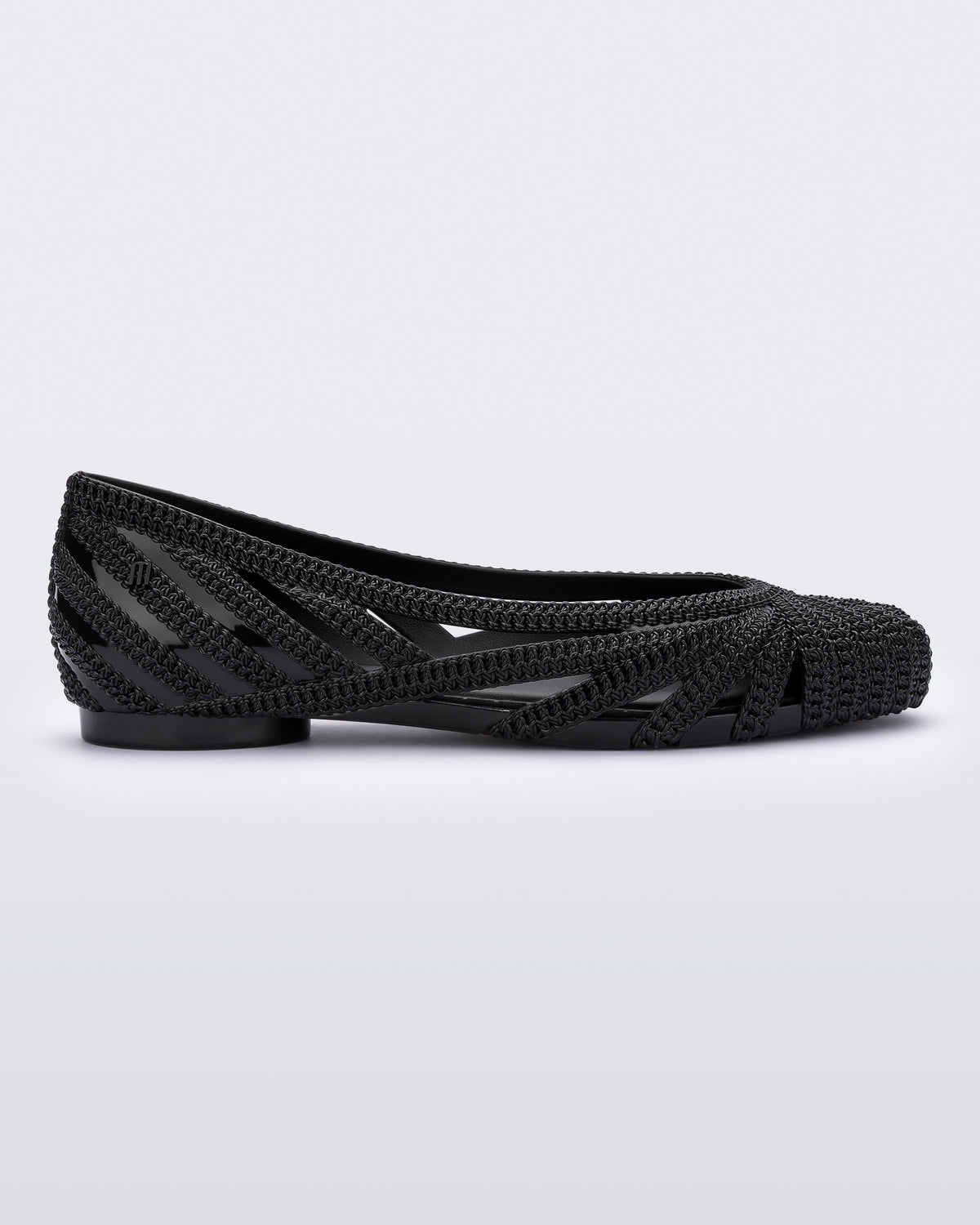 Side view of a black Melissa Femme Classy flat with a woven design.