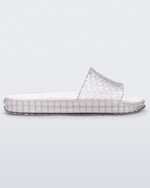 Side view of a clear/white Melissa Court Slide with a checkered pattern texture.