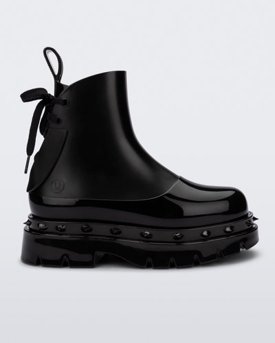 Side view of a black Melissa Spikes Boot with spike details around the sole and laces in the back.