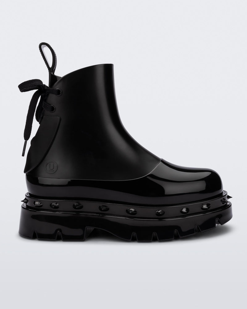 Side view of a black Melissa Spikes Boot with spike details around the sole and laces in the back.
