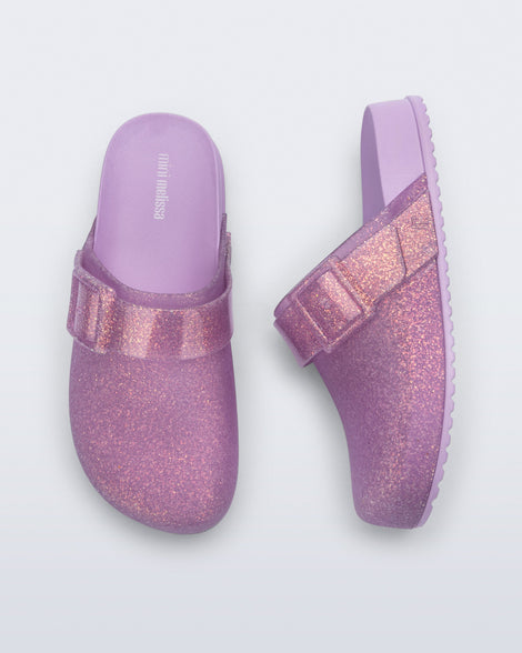 Side and top view of a pair of glitter lilac Cozy Clog for kids