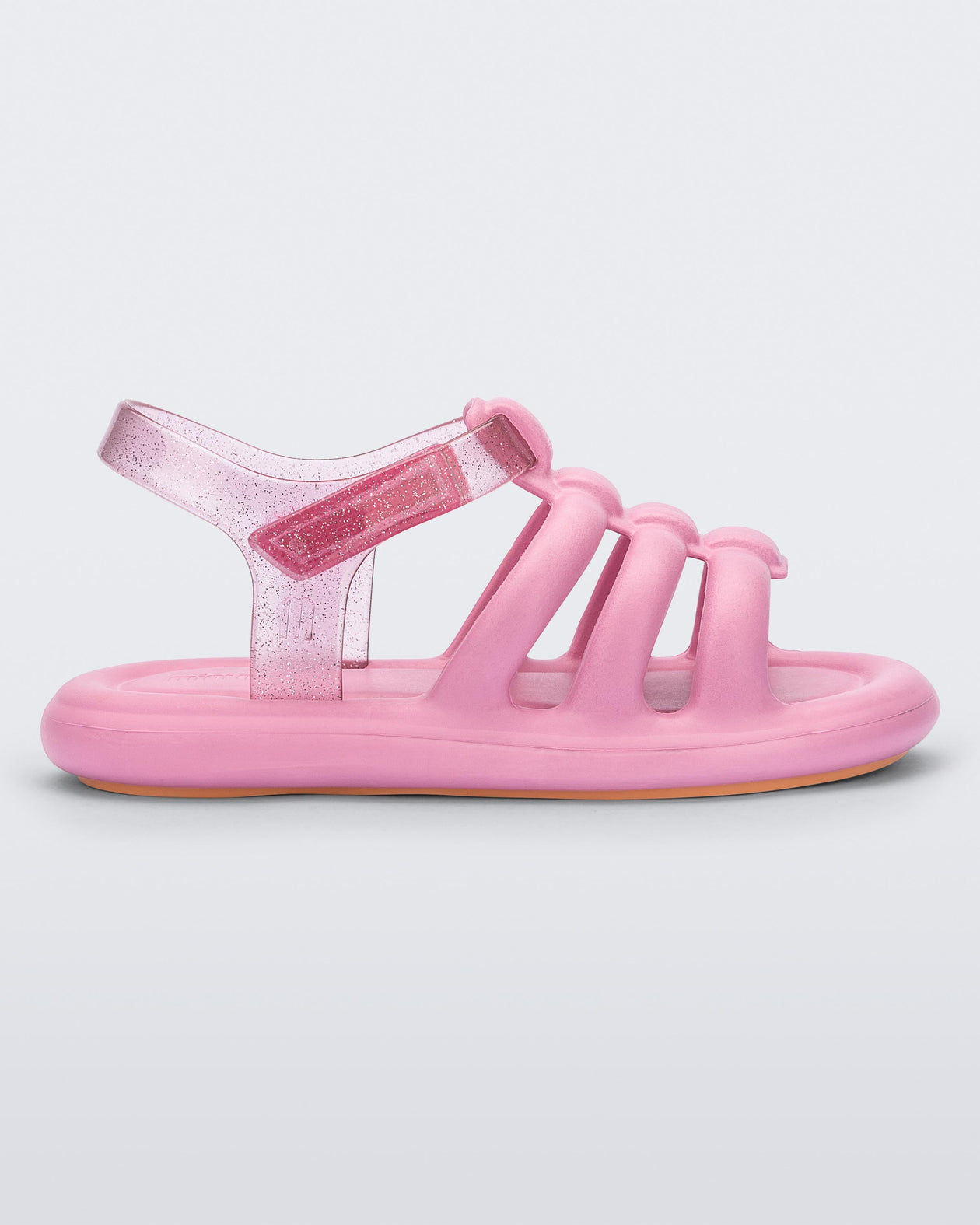 Side view of a pink Mini Melissa Freesherman sandal with pink and clear glitter straps.