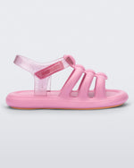 Side view of a pink Mini Melissa Freesherman sandal with pink and clear glitter straps.