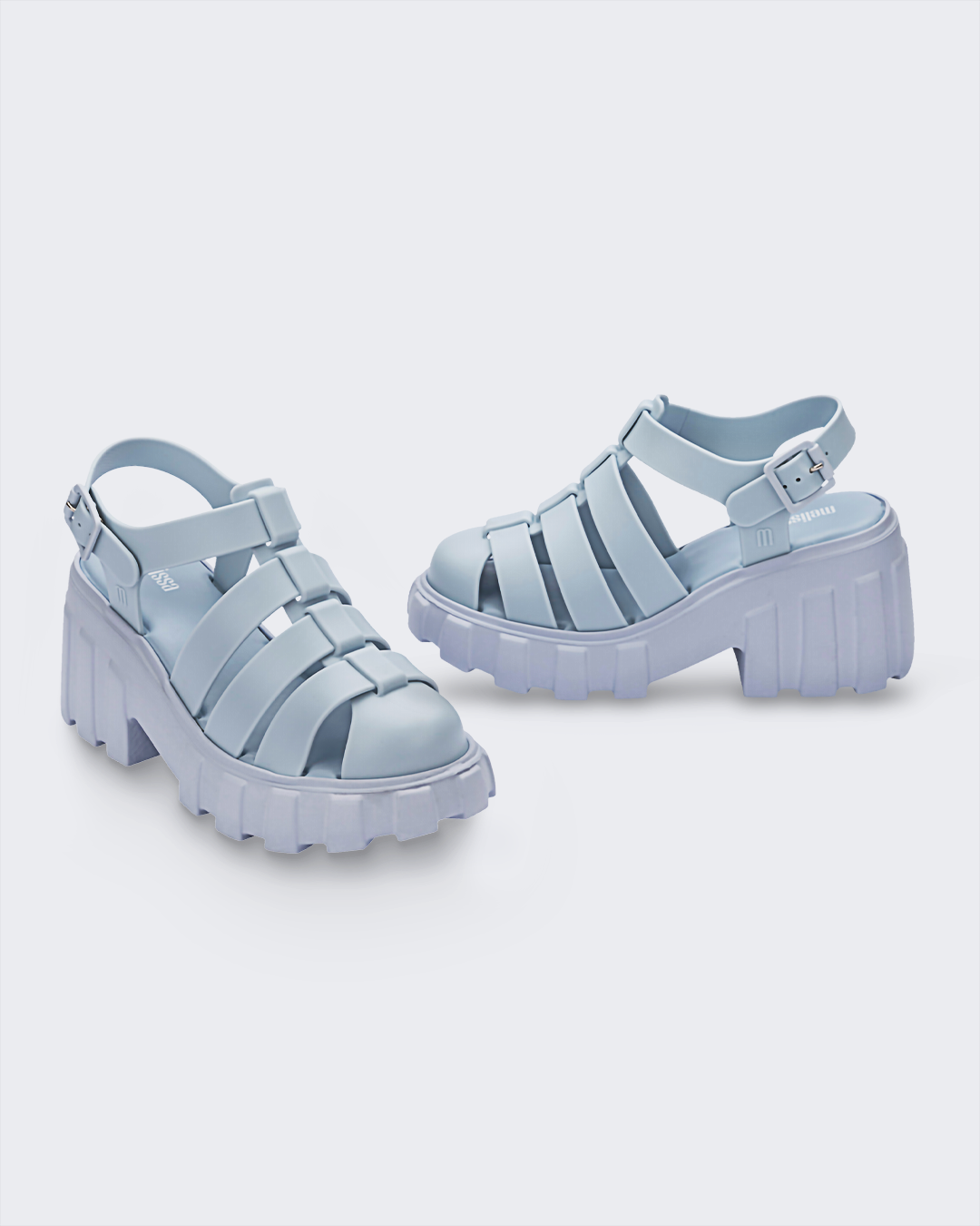 Angled view of a pair of Melissa Megan platform sandals in light blue