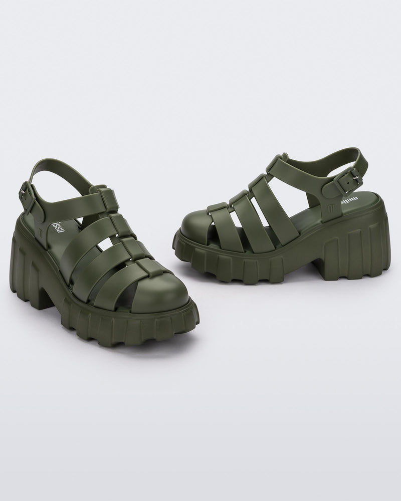 Angled view of a pair of dark green Melissa Megan Platform heels.