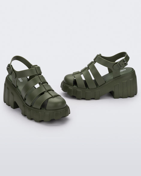 Angled view of a pair of dark green Melissa Megan Platform heels.