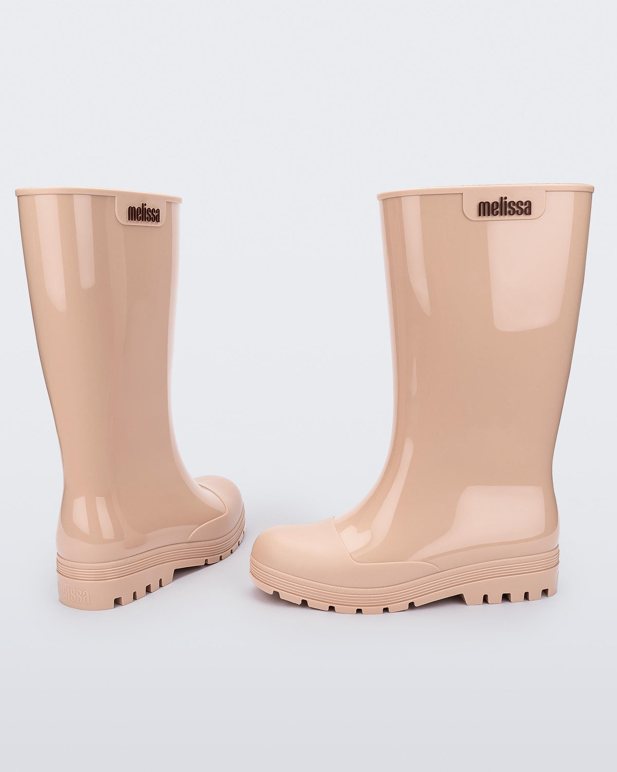 Back and side view of a pair of beige Melissa Welly boots.