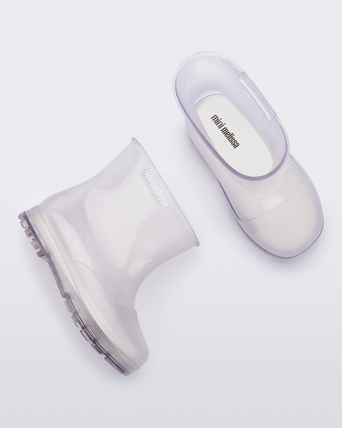 Top and side view of a pair of clear baby Melissa Welly boots.