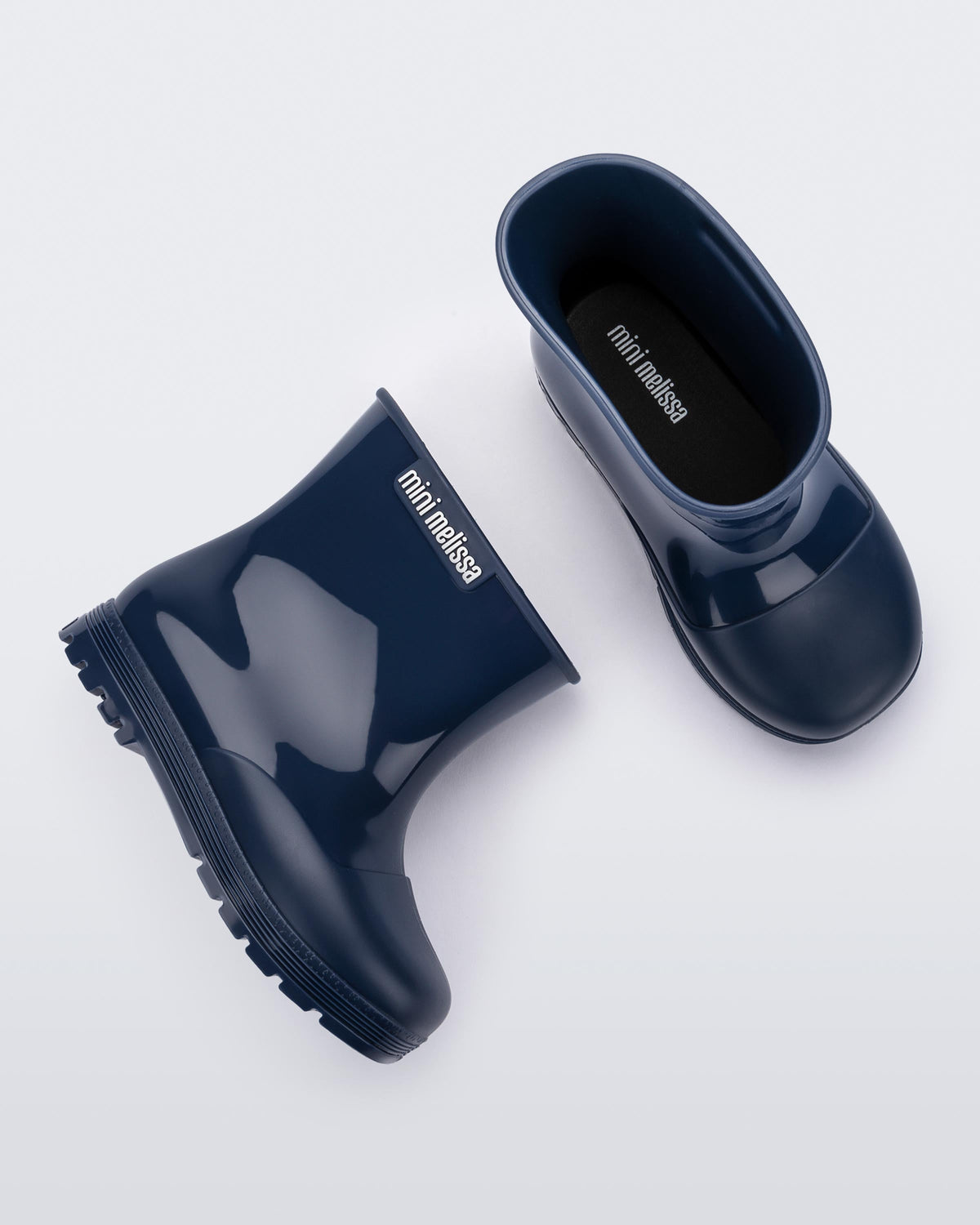 Top and side view of a pair of blue baby Melissa Welly boots.