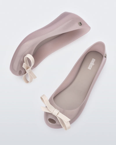 Side and top view of a pair of beige Ultragirl Bow flats.