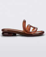 Side view of a Melissa Jelly Slides + Telfar in brown.