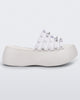 Side view of a White/Clear Melissa Punk Love Becky platform slide with a white base and several top straps with spike stud details.