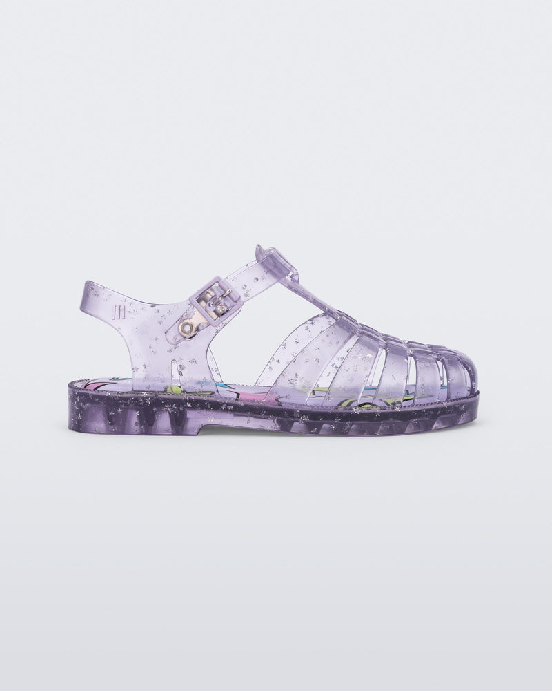 Side view of a clear lilac Possession kids sandal with star glitter