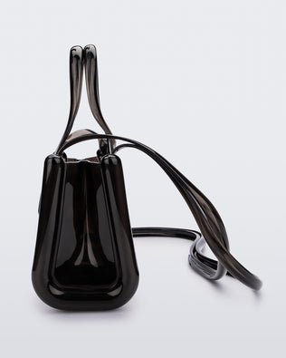 Side view of a black small Melissa Jelly Shopper bag + Telfar bag with a handle and straps.