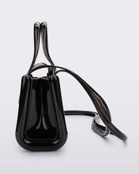 Side view of a black small Melissa Jelly Shopper bag + Telfar bag with a handle and straps.