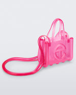 Angled view of a pink small Melissa Jelly Shopper bag + Telfar bag with a handle and straps.