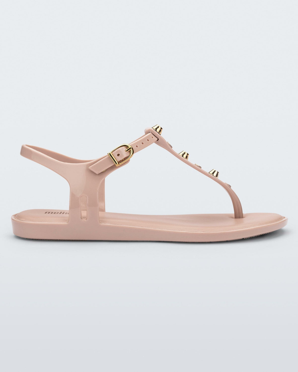Side view of a pink Melissa Solar studs sandal with gold studded t-strap and gold buckle.