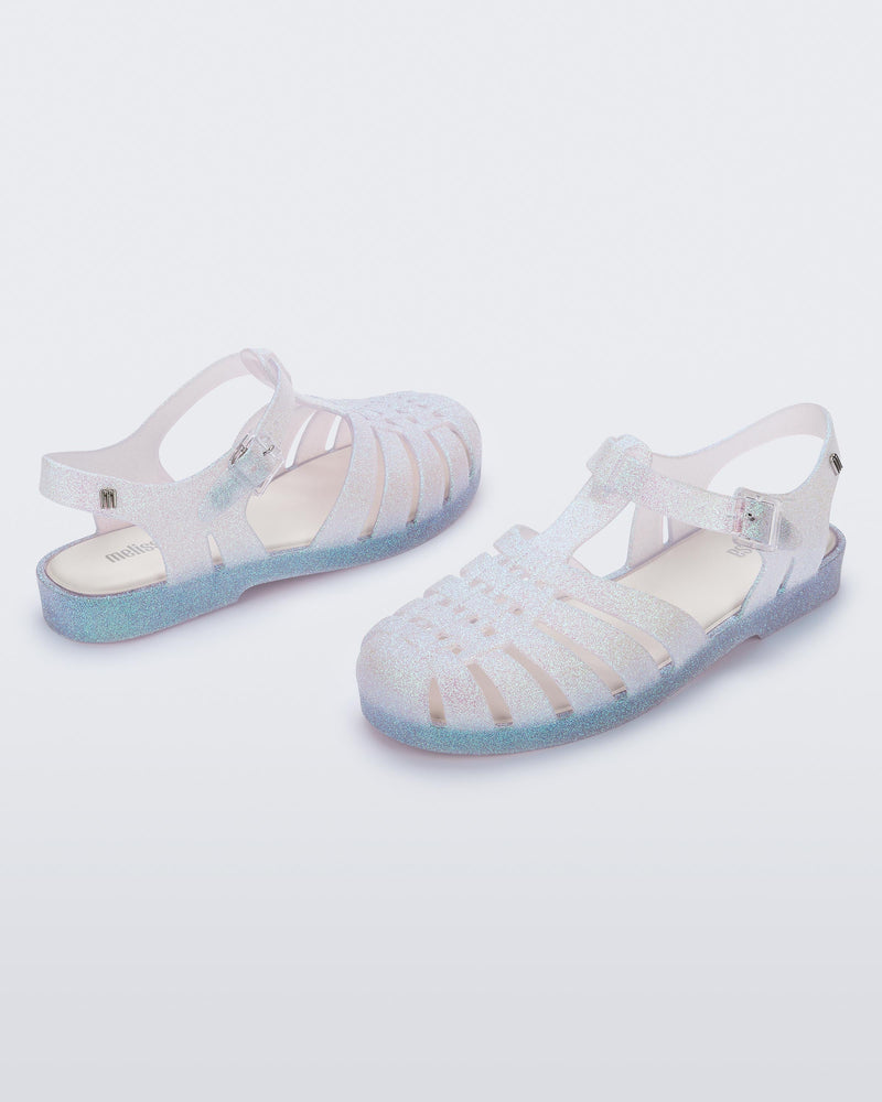 Angled view of a pair of clear glitter Possession sandal.