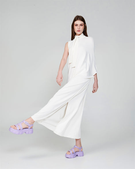 Model in a white outfit wearing a pair of lilac Ella platform sandals
