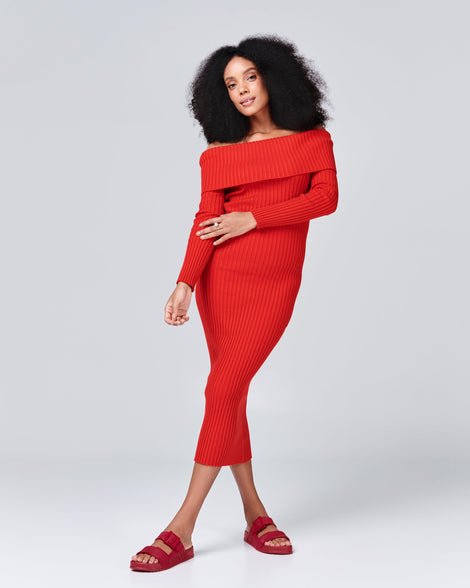 Model in a red dress wearing a pair of red Cozy Connection slides