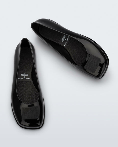Side and angled view of a pair of black Ruby + Marc Jacobs flats