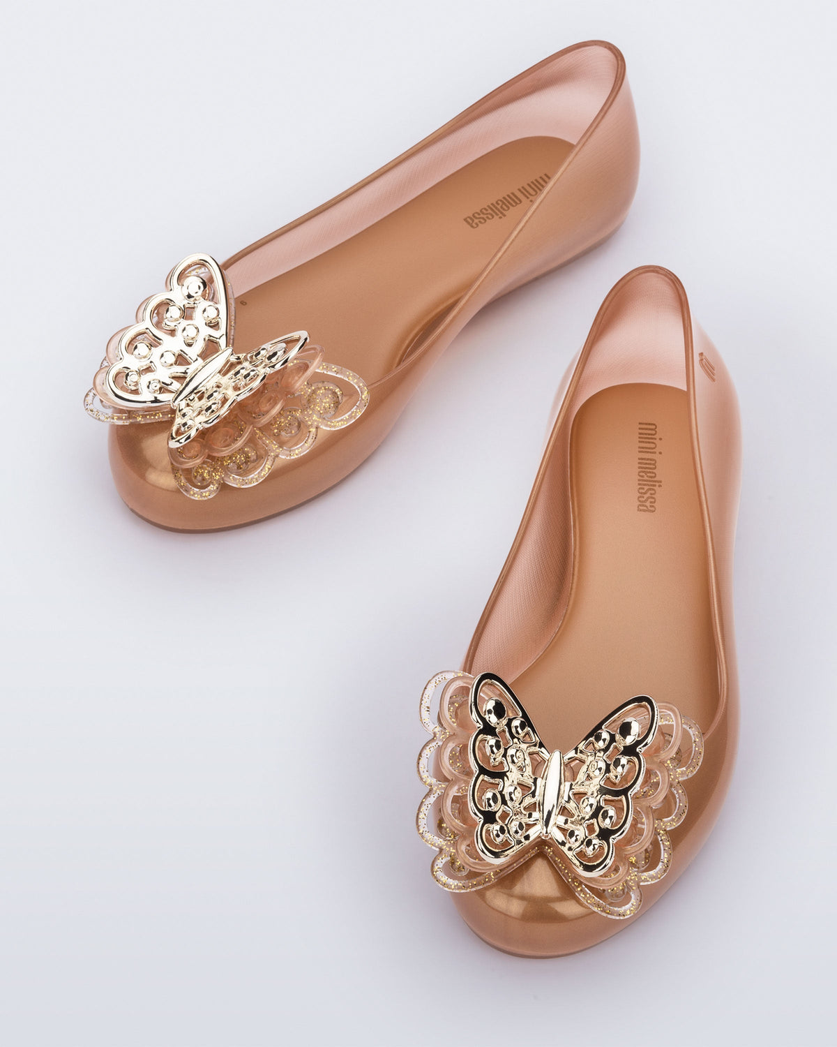 Top angled view of a pair of gold Sweet Love Butterfly kids flats.