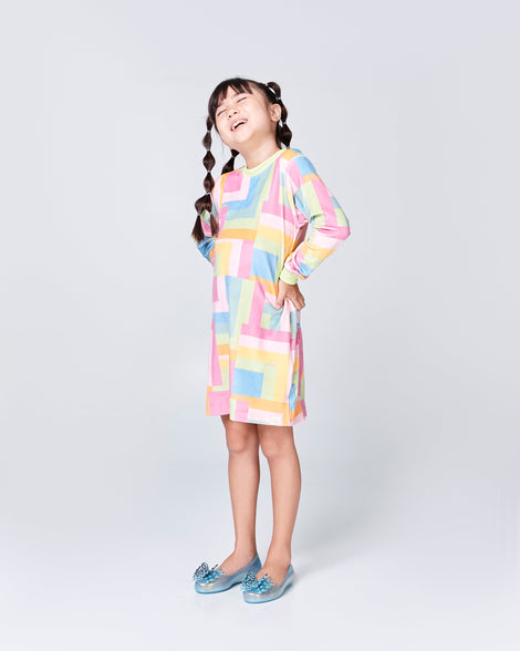 Child model in a multi color dress wearing a pair of blue Sweet Love kids flats