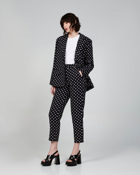 Model in a polka dot suit wearing a pair of black Dance Heel platforms