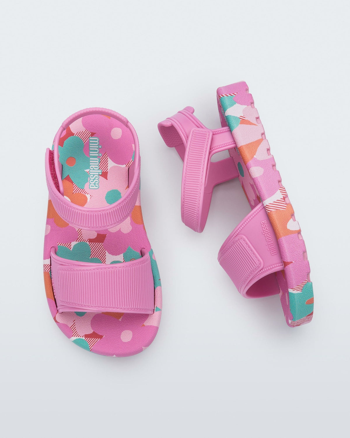 Top and side view of a pair of pink baby Imagine sandals