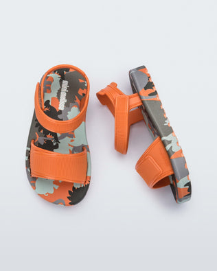 Side and top view of a pair of orange baby Imagine sandals.