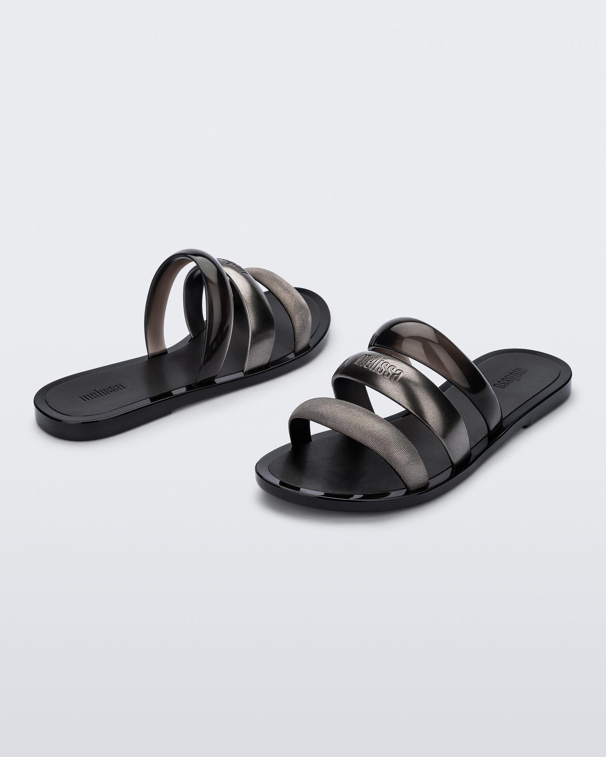Back and angled view of a pair of black Eclipse Slides with gold and black straps.