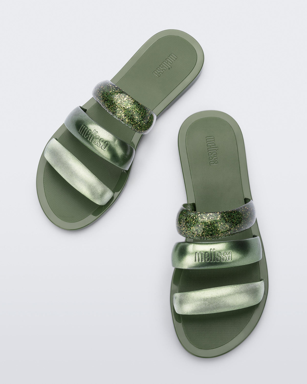 Top view of a pair of green Eclipse Slides with glitter green straps.