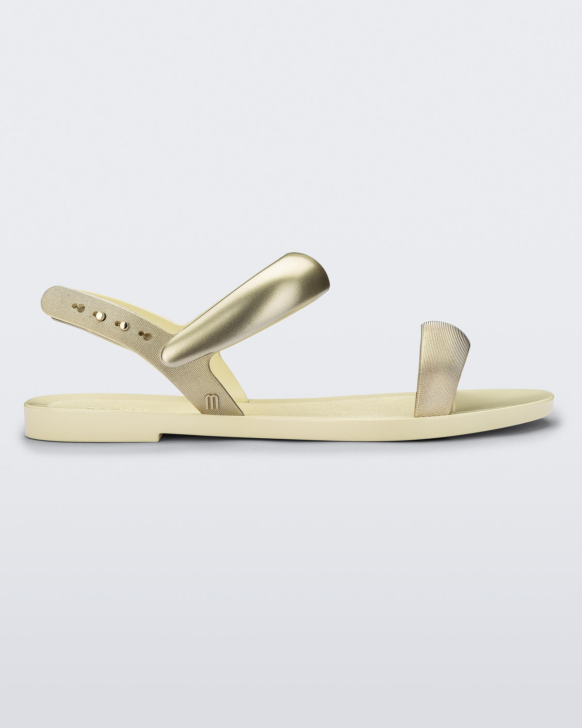 Side view of a beige Eclipse Sandal with gold straps.
