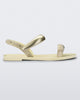 Side view of a beige Eclipse Sandal with gold straps.