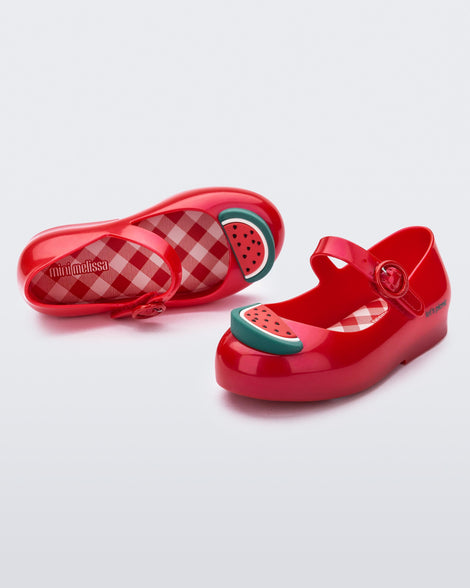 Angled and top view of a pair of red Sweet Love Picnic baby flats with watermelon slices