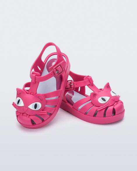 Angled view of a pair of pink baby Possession Cat sandals