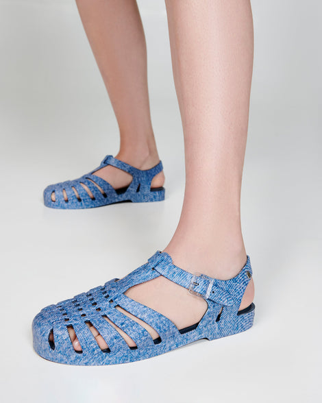 Model's legs in a pair of blue jean Possession sandals