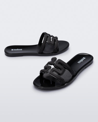 Angled view of a pair of black M Slides.