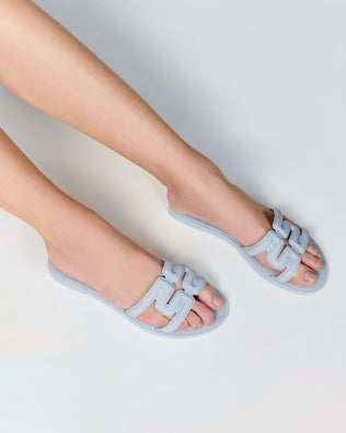 Model's legs in a pair of light blue M Slides.