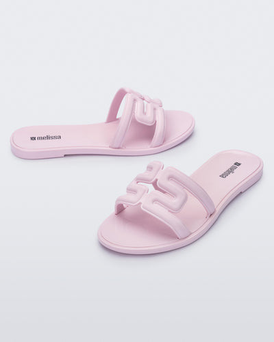 Angled view of a pair of light pink M Slides.