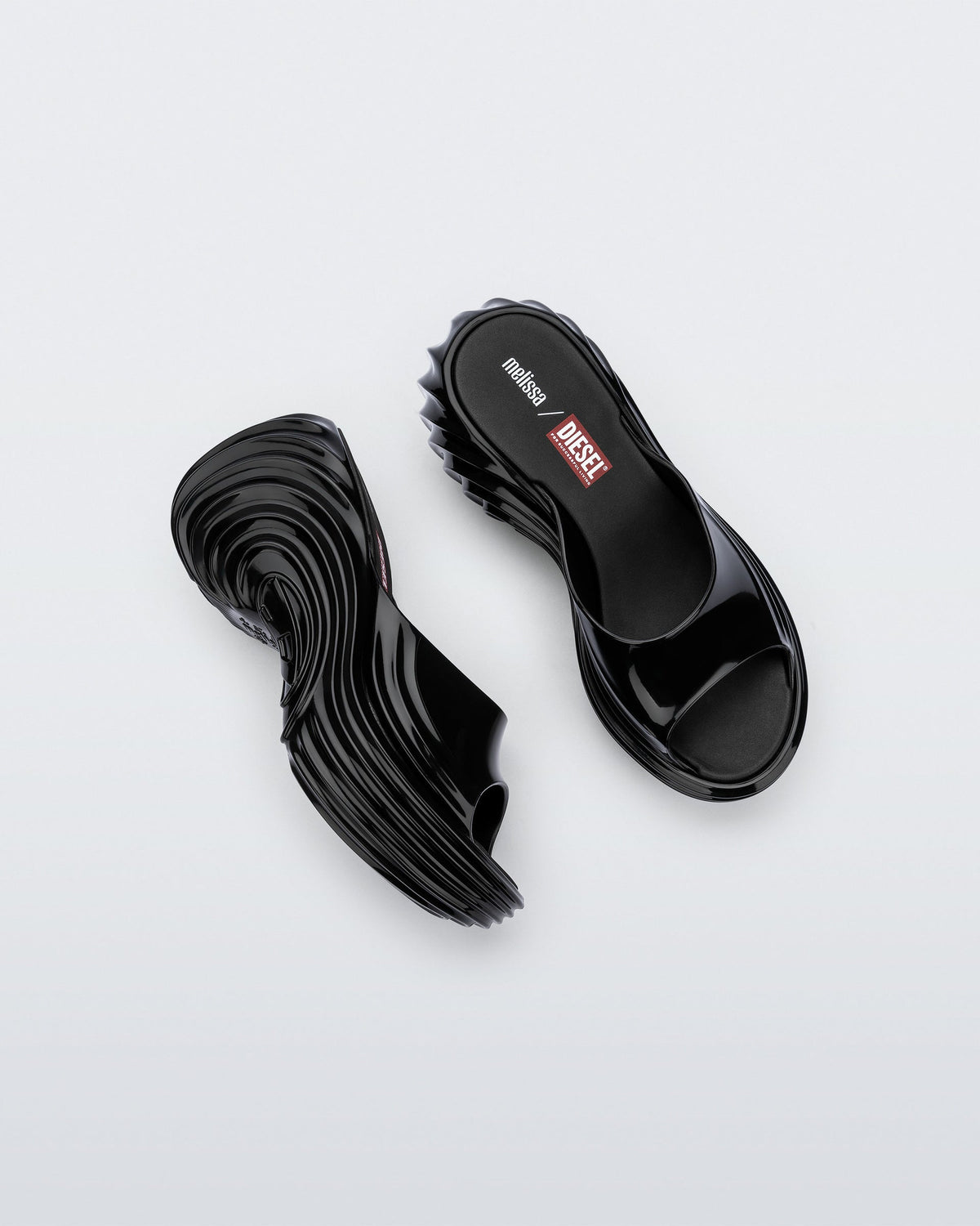 Top and side view of a pair of black Platforms + Diesel slides