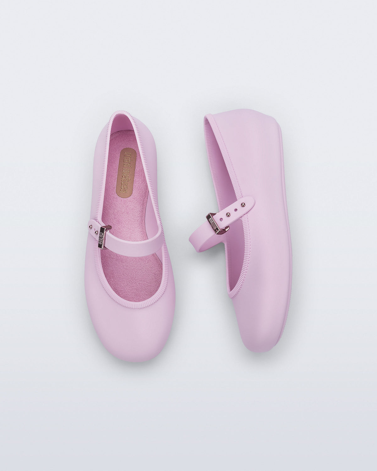 Top and side view of a pair of pink kids Soft ballerinas with strap and buckle
