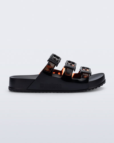 Side view of a black Cozy Stripe slide with tortoise colored straps