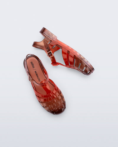 Top and side view of a pair of transparent red Possession + Nodaleto fisherman sandals