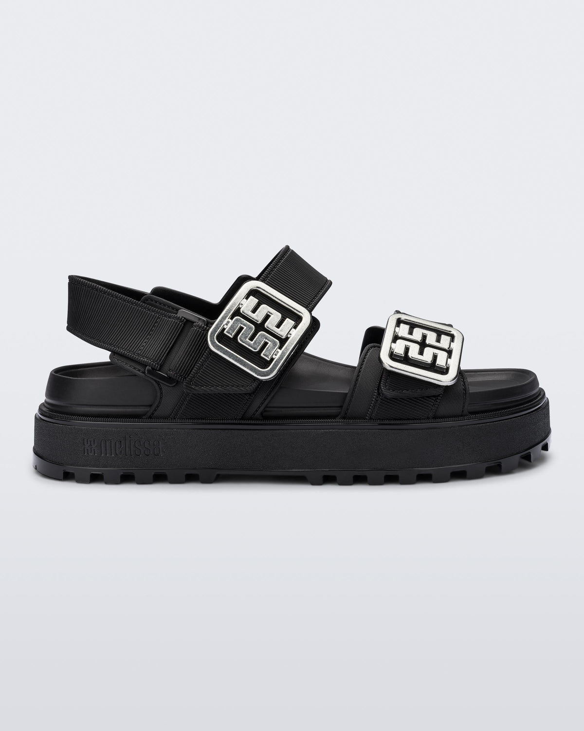 Side view of a black Towny sandal with straps and silver buckle