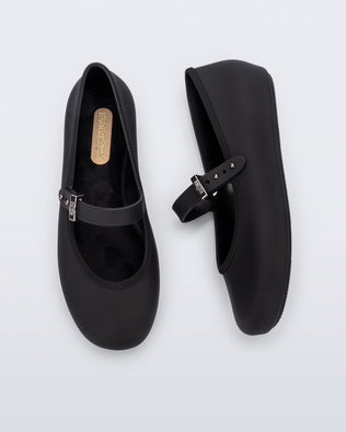 Top and side view of a pair of black Soft Ballerina kids flat with strap