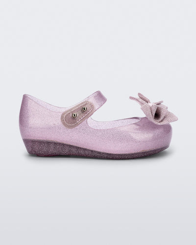 Side view of a pink glitter Ultragirl Sweet baby ballerina flat with bow